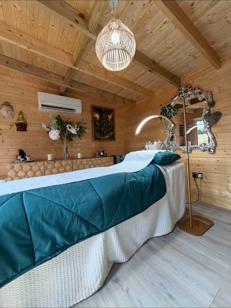 The length of the treatment bed, with carved Buddha heads on the pine wall beyond