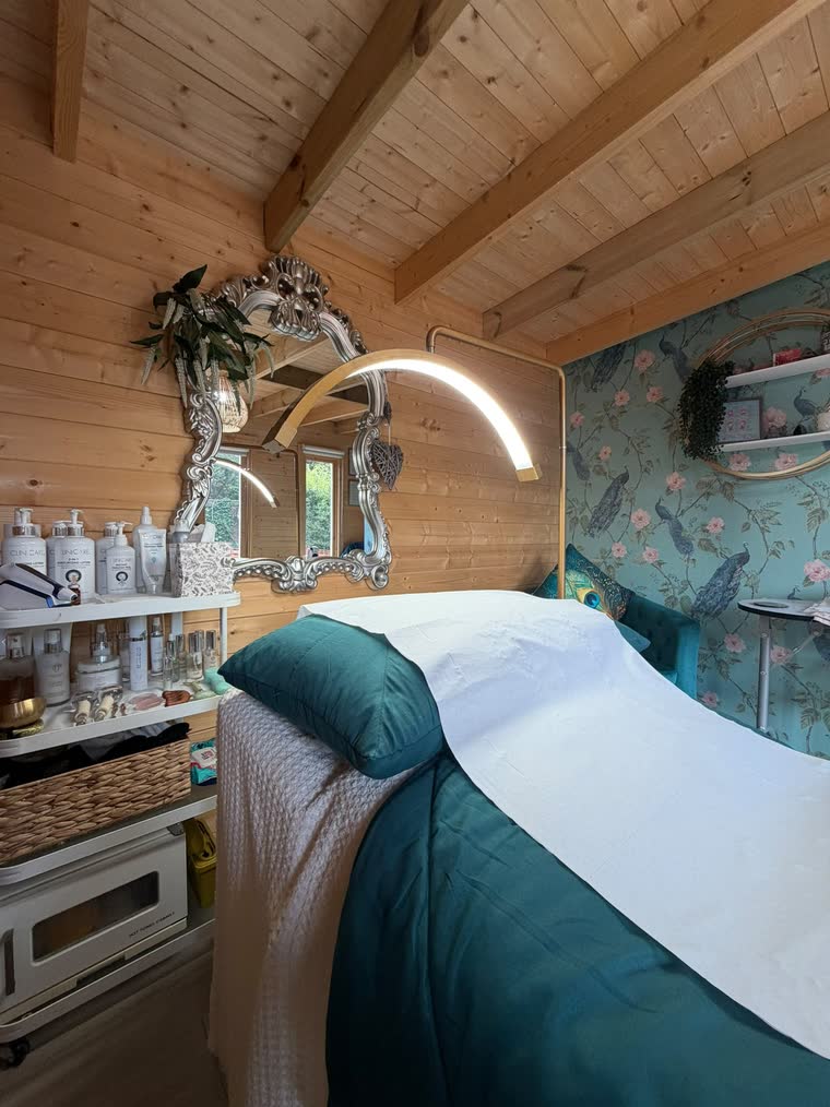 Clinicare cleansing and moisturising bottles on the shelf beside the treatment bed